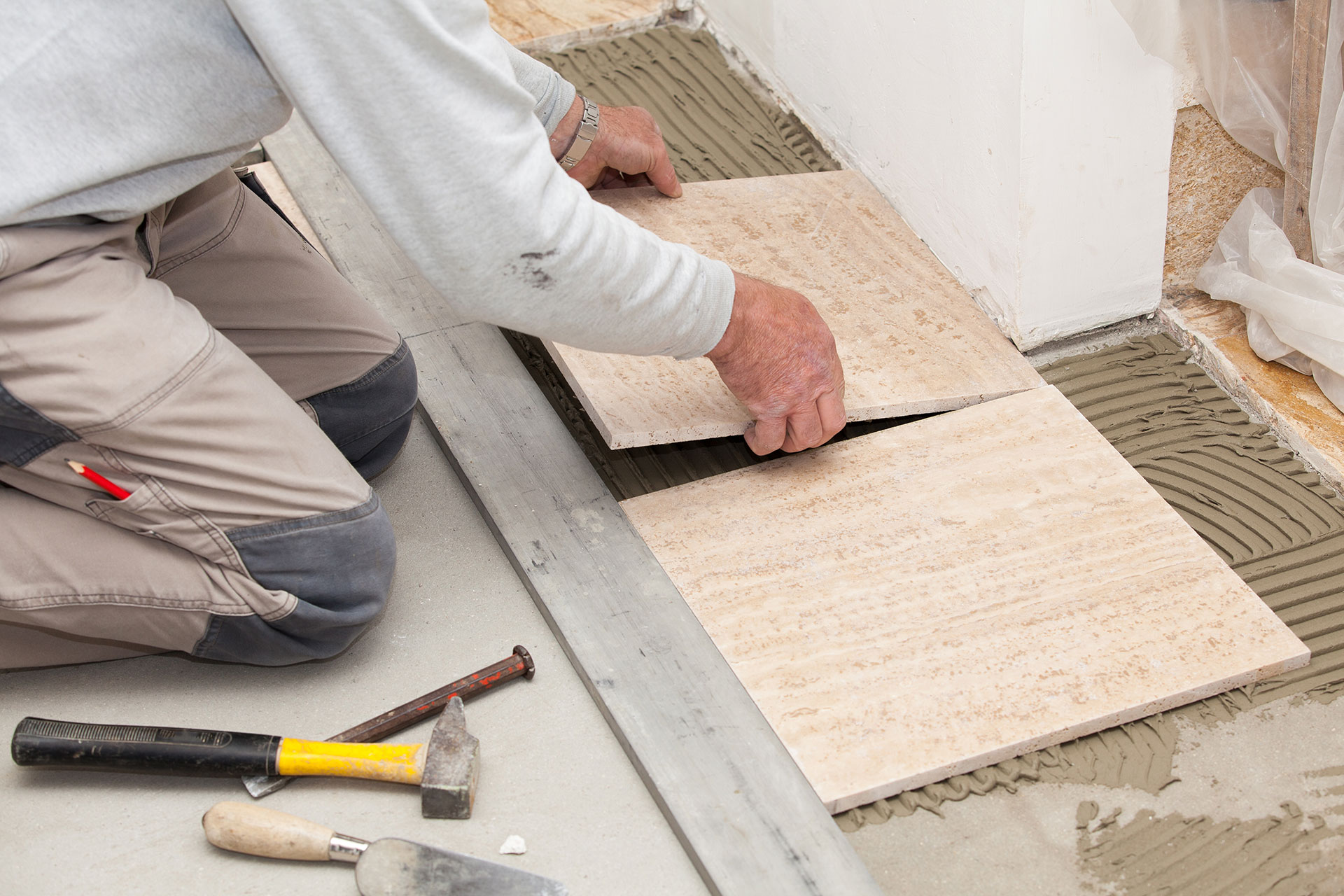 Man laying Tiles